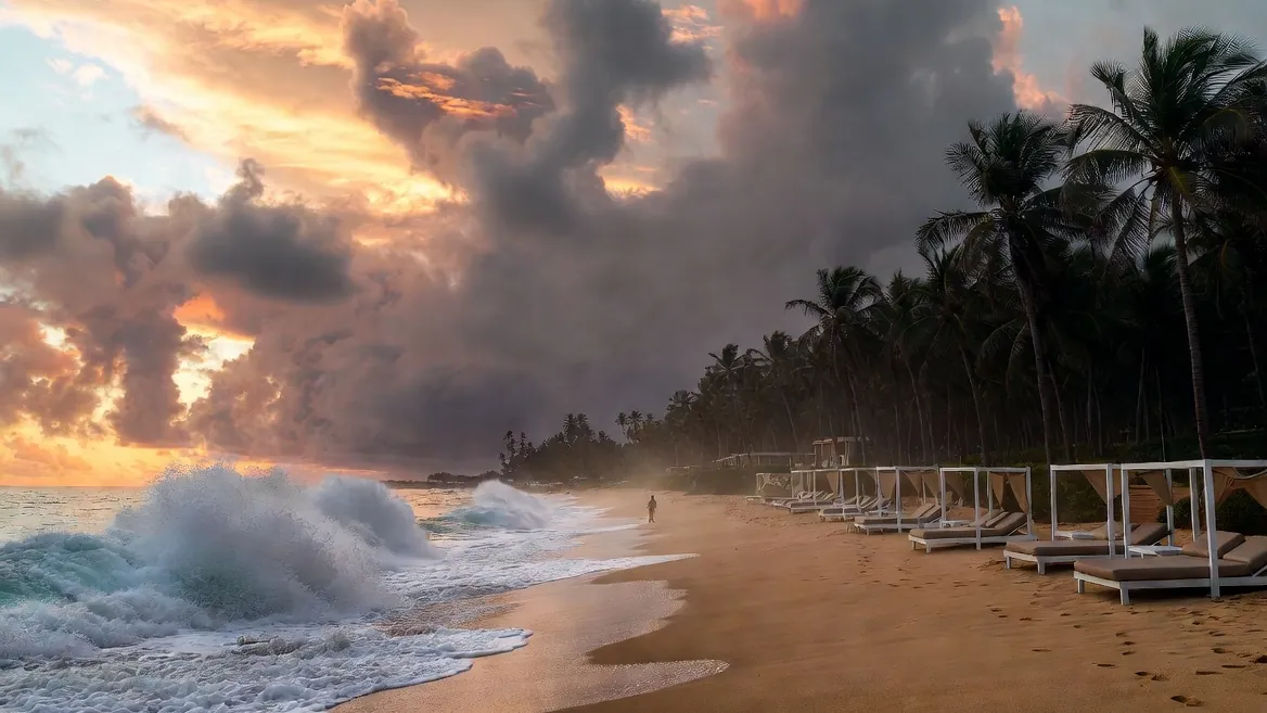 Bacocho's long open beach at sunset, heavy shorebreak rolling in past the beach clubs