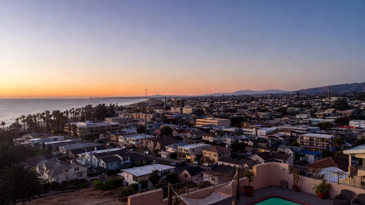 Puerto Escondido's neighborhoods at dusk from a rooftop terrace — six towns bolted onto one coast